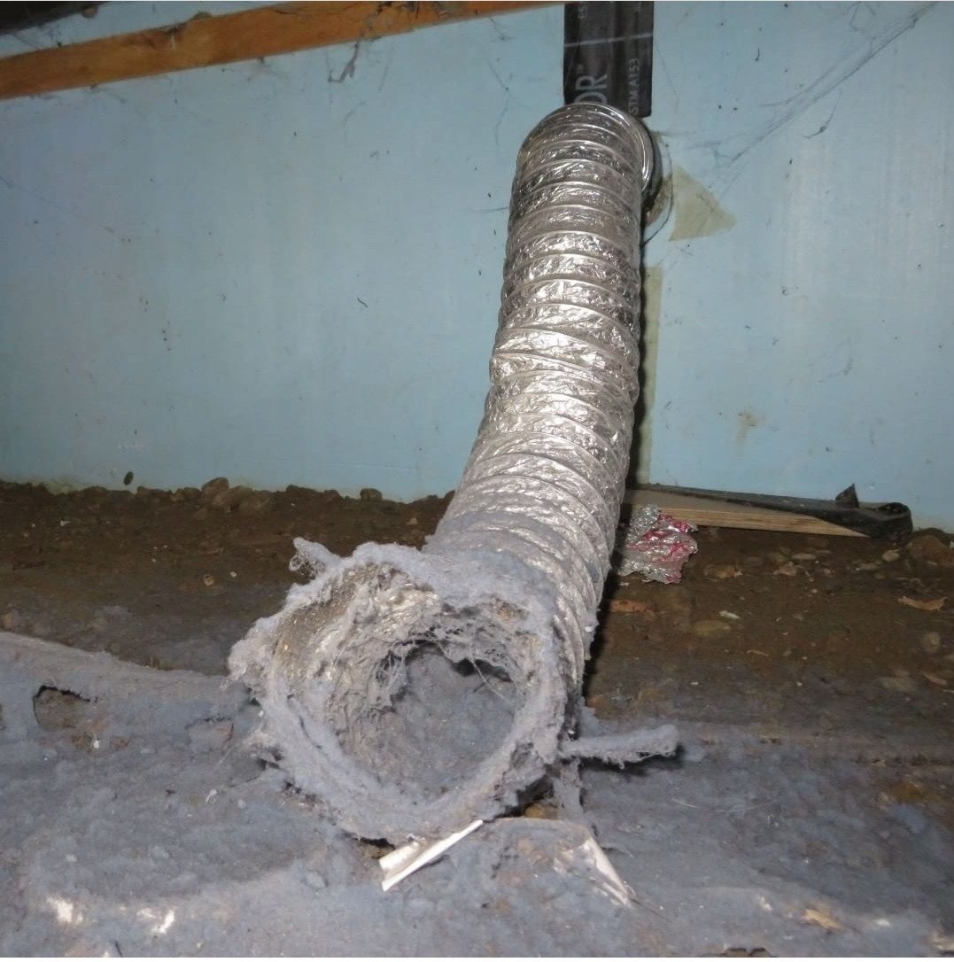 Long flexible foil dryer hose used as a permanent duct run, its open end packed with lint